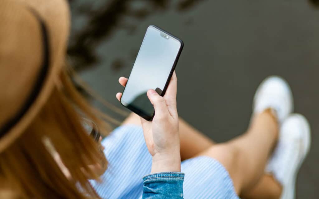 A woman maximizing engagement on Instagram with her smart phone.