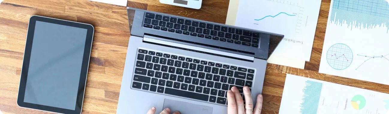 A Facebook Ad Agency Employee Using A Laptop Computer On Their Desk.