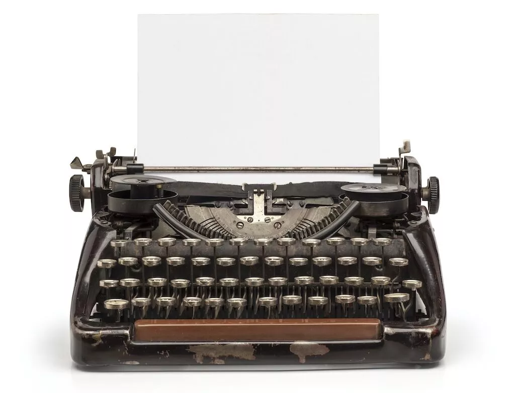An Old-Fashioned Typewriter With A Blank Sheet Of Paper For Building An Instagram Strategy.